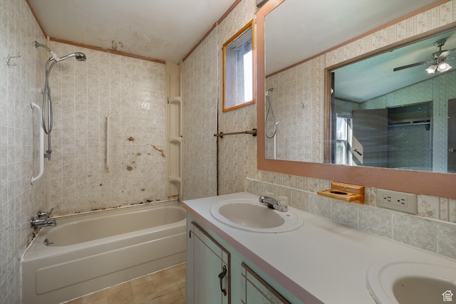 full bath featuring a sink, bathing tub / shower combination, tile walls, double vanity, and wallpapered walls
