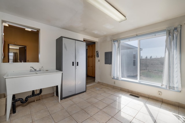 bedroom with electric panel, visible vents, baseboards, and light tile patterned flooring