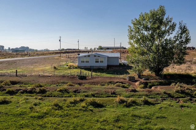 view of yard featuring a rural view and fence