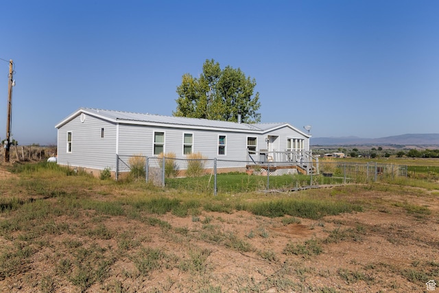 exterior space with fence and metal roof