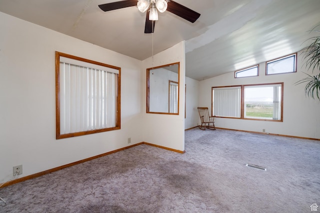 unfurnished room with visible vents, baseboards, ceiling fan, carpet, and vaulted ceiling