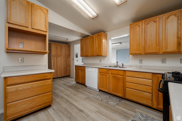 kitchen with black gas range oven, vaulted ceiling, white dishwasher, a sink, and light wood-type flooring