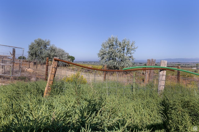 view of gate featuring a rural view and fence