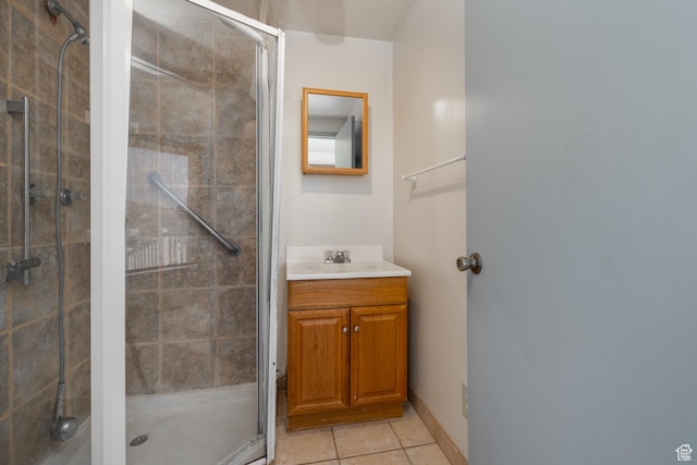 full bath with a shower stall, tile patterned flooring, and vanity