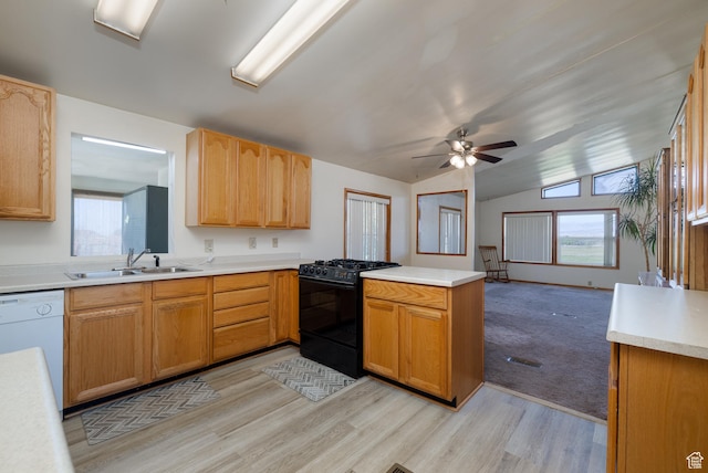 kitchen with white dishwasher, a peninsula, a sink, light countertops, and gas stove