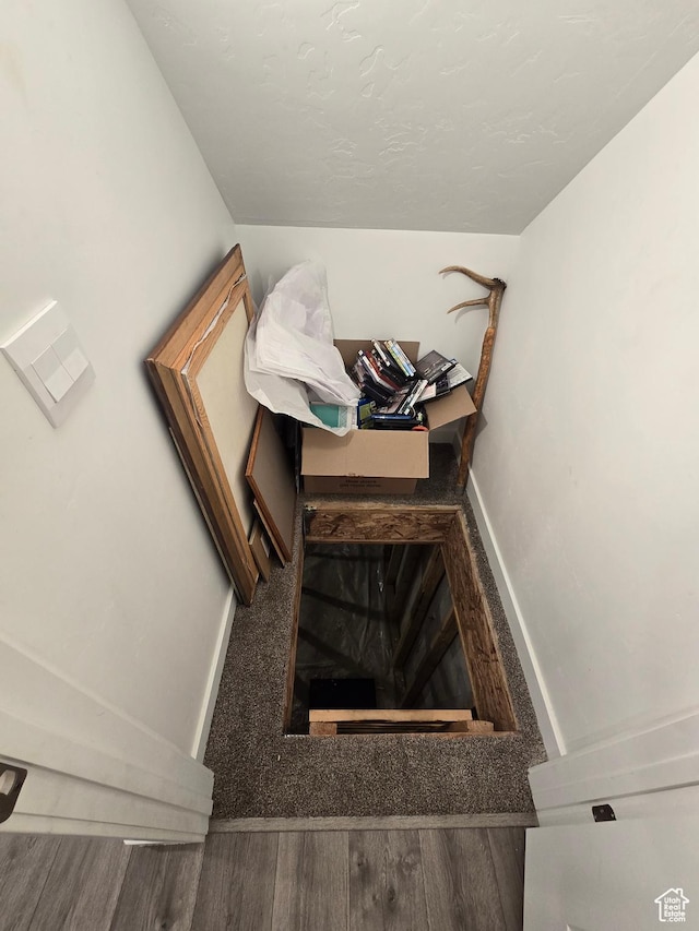 stairway with baseboards and wood finished floors