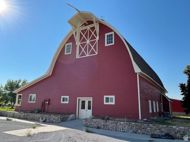 view of home's exterior with an outbuilding and a barn