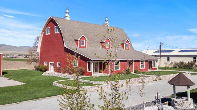 15125 N 4400 W, Garland, UT 84312 - view of front facade with a front yard, a barn, a porch, and a mountain view