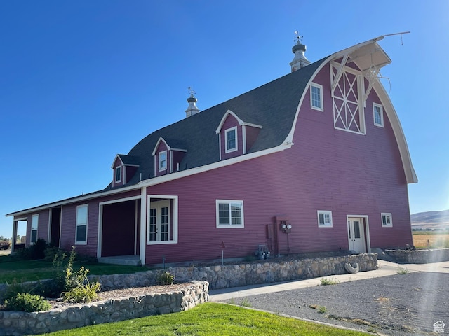 view of home's exterior featuring an outdoor structure and a barn