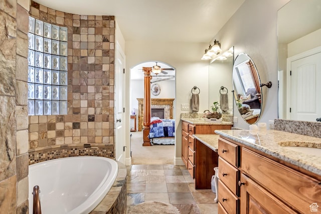 2118 S Centennial Blvd S, Saratoga Springs, UT 84045 - ensuite bathroom with a glass covered fireplace, a garden tub, plenty of natural light, and vanity