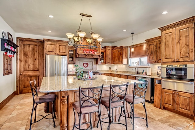 2118 S Centennial Blvd S, Saratoga Springs, UT 84045 - kitchen with stainless steel appliances, a warming drawer, brown cabinetry, light stone countertops, and recessed lighting