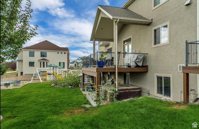 2118 S Centennial Blvd S, Saratoga Springs, UT 84045 - back of property with a covered hot tub, stucco siding, and a lawn