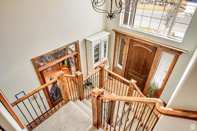 2118 S Centennial Blvd S, Saratoga Springs, UT 84045 - carpeted foyer entrance with a towering ceiling, a chandelier, plenty of natural light, and stairs