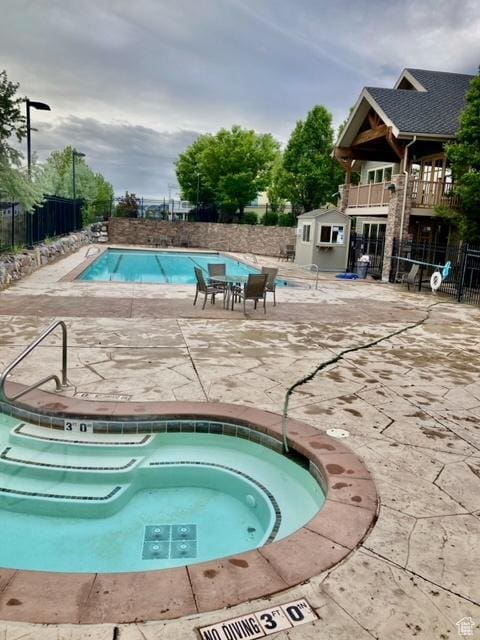 2118 S Centennial Blvd S, Saratoga Springs, UT 84045 - community pool with fence, a patio, and a hot tub