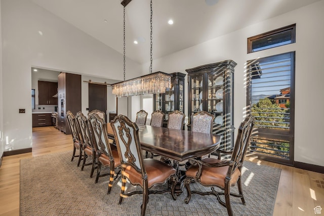 dining space featuring recessed lighting, baseboards, and light wood-type flooring