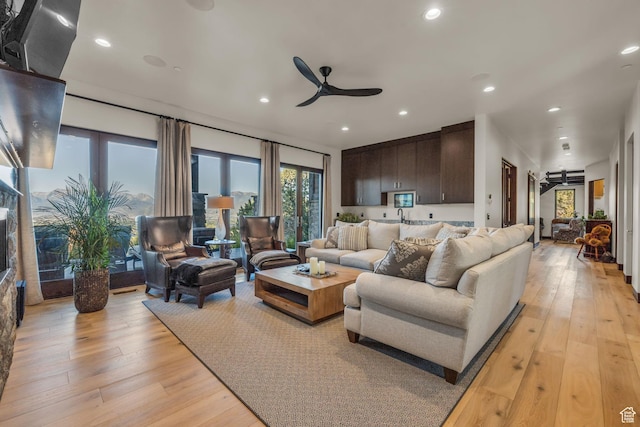 living room featuring recessed lighting, light wood-style flooring, and ceiling fan
