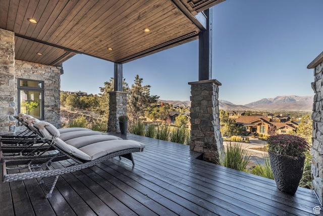 wooden terrace featuring a residential view and a mountain view