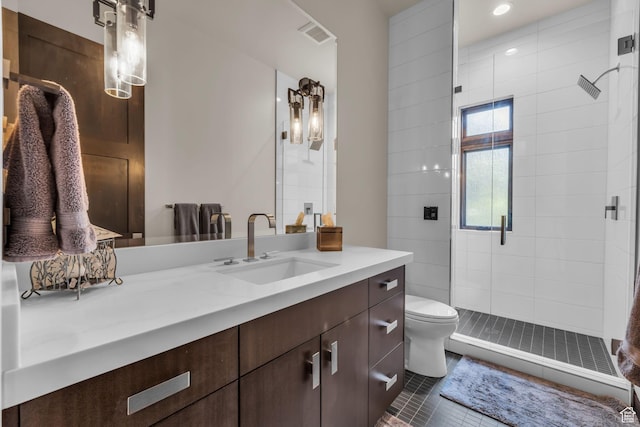 bathroom with tile patterned floors, toilet, a stall shower, visible vents, and vanity