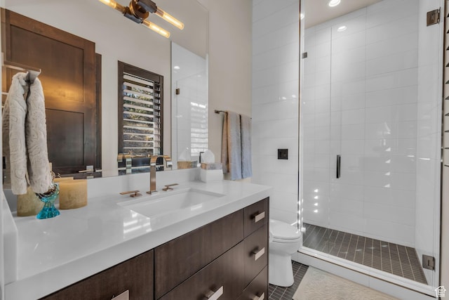 full bathroom featuring a shower stall, toilet, vanity, and tile patterned floors