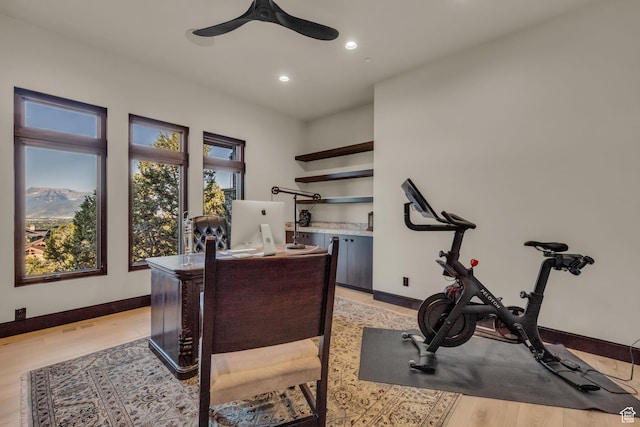 office featuring a ceiling fan, baseboards, recessed lighting, and light wood-style floors
