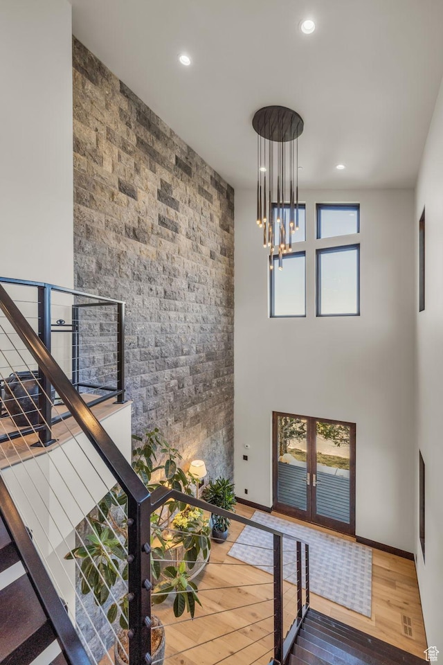 foyer entrance featuring recessed lighting, an inviting chandelier, hardwood / wood-style flooring, and french doors