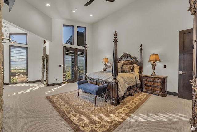 bedroom with access to exterior, light carpet, french doors, baseboards, and high vaulted ceiling