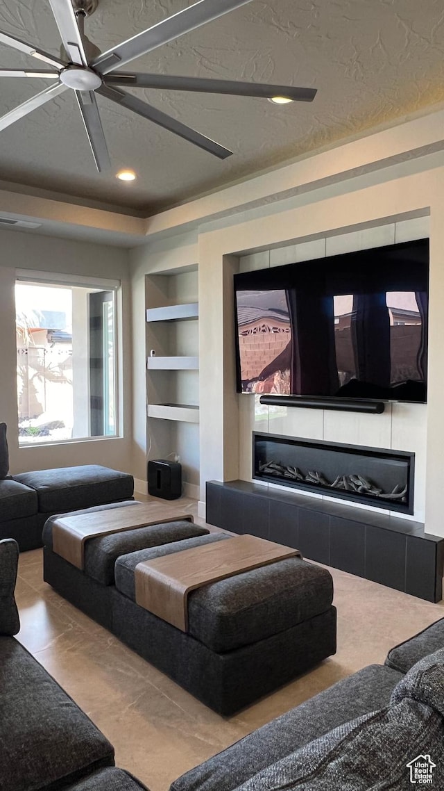 5178 W 2150 S, Hurricane, UT 84737 - home theater with built in shelves, recessed lighting, a ceiling fan, a tiled fireplace, and a textured ceiling