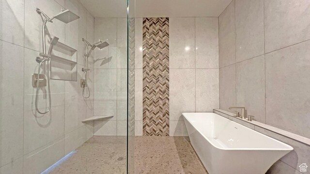 5178 W 2150 S, Hurricane, UT 84737 - bathroom featuring walk in shower, a freestanding bath, and tile walls