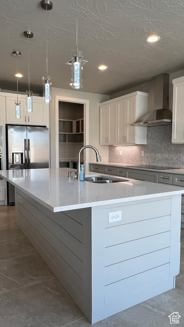 5178 W 2150 S, Hurricane, UT 84737 - kitchen featuring wall chimney exhaust hood, a sink, a large island, light stone countertops, and backsplash
