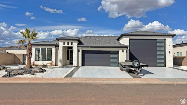 5178 W 2150 S, Hurricane, UT 84737 - prairie-style house featuring a garage, stone siding, and driveway