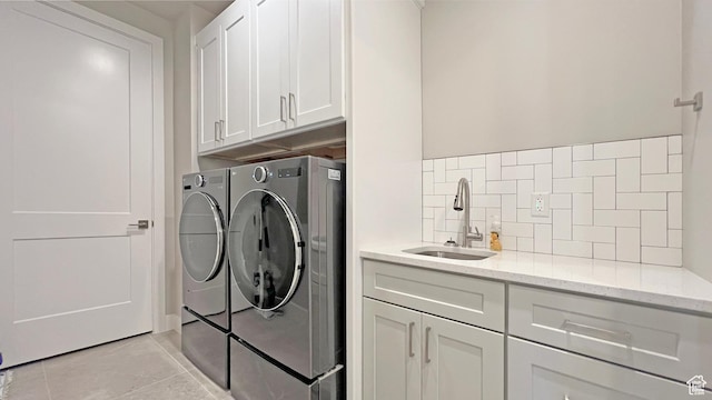 5178 W 2150 S, Hurricane, UT 84737 - laundry room with washer and dryer, cabinet space, light tile patterned floors, and wet bar