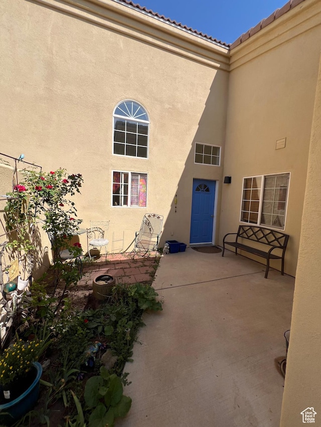 592 W Hale Ave, Moab, UT 84532 - doorway to property featuring stucco siding, a patio, and a tiled roof