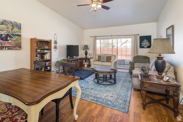 592 W Hale Ave, Moab, UT 84532 - living room with vaulted ceiling, wood finished floors, ceiling fan, and a baseboard heating unit
