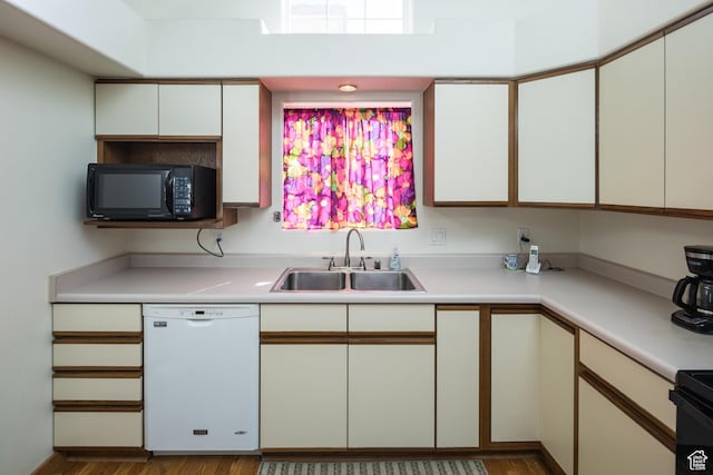 592 W Hale Ave, Moab, UT 84532 - kitchen featuring dishwasher, a sink, black microwave, light countertops, and wood finished floors