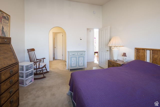 592 W Hale Ave, Moab, UT 84532 - bedroom featuring arched walkways, carpet, and a high ceiling