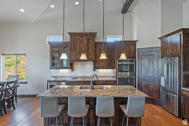 1375 E Lasso Trl, Hideout, UT 84036 - kitchen with high vaulted ceiling, light stone counters, stainless steel appliances, and sink