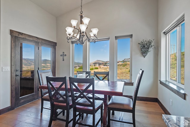 1375 E Lasso Trl, Hideout, UT 84036 - dining space featuring high vaulted ceiling, wood-type flooring, a wealth of natural light, and a notable chandelier