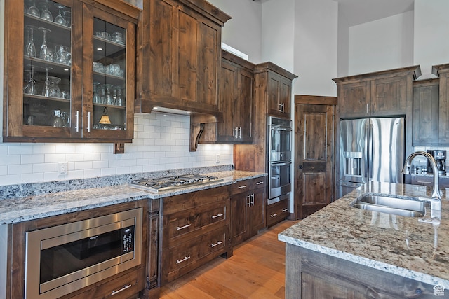 1375 E Lasso Trl, Hideout, UT 84036 - kitchen with wood-type flooring, stainless steel appliances, sink, and dark brown cabinetry