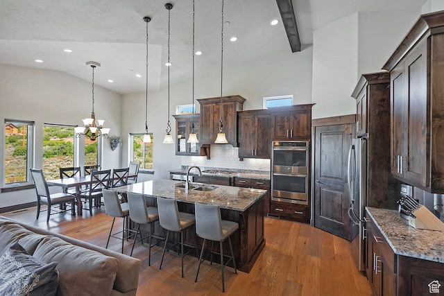 1375 E Lasso Trl, Hideout, UT 84036 - kitchen with dark stone countertops, pendant lighting, and hardwood / wood-style flooring