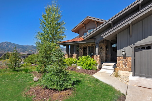 1375 E Lasso Trl, Hideout, UT 84036 - view of property exterior with a mountain view, a lawn, covered porch, and a garage