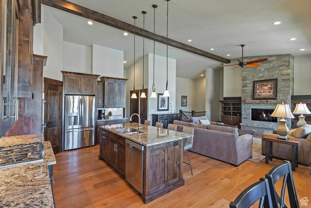 1375 E Lasso Trl, Hideout, UT 84036 - kitchen featuring light stone countertops, a fireplace, stainless steel appliances, sink, and ceiling fan