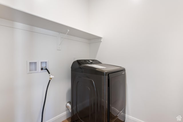 laundry area featuring baseboards, washer / clothes dryer, wood finished floors, and laundry area