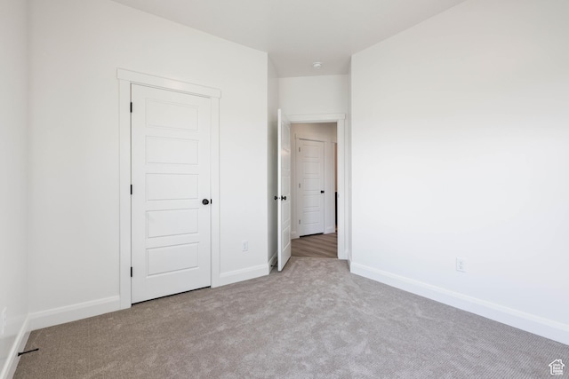 unfurnished bedroom with carpet floors and baseboards