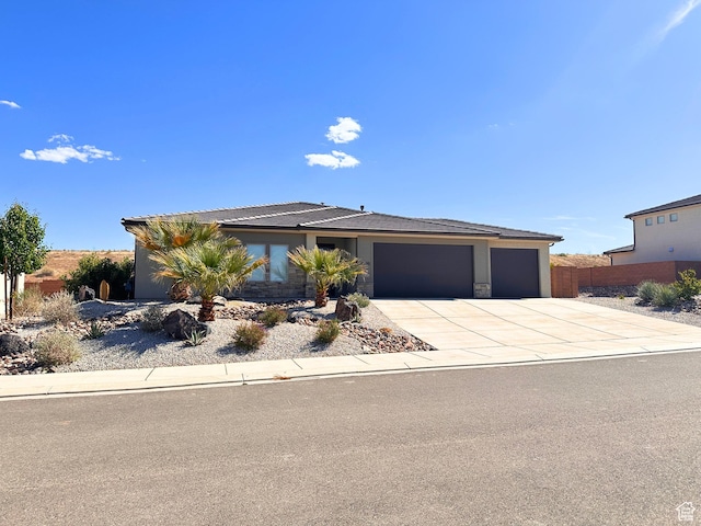 view of front of property featuring concrete driveway and a garage