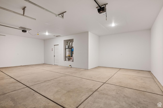 garage featuring water heater and a garage door opener