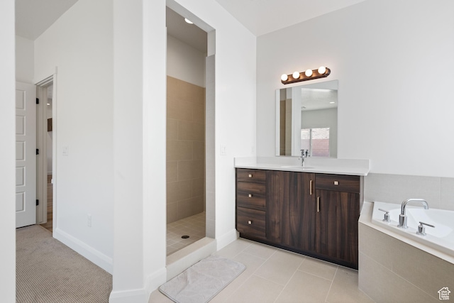 bathroom with a garden tub, tile patterned flooring, vanity, and tiled shower
