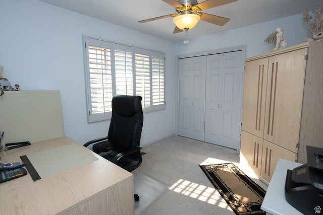 office area featuring ceiling fan and light carpet