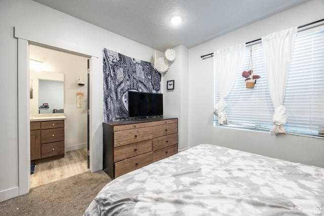 67 E 500 S Unit B102, Heber City, UT 84032 - bedroom featuring carpet flooring, multiple windows, ensuite bath, and baseboards