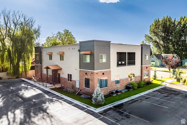 67 E 500 S Unit B102, Heber City, UT 84032 - view of side of property with uncovered parking, brick siding, and stucco siding