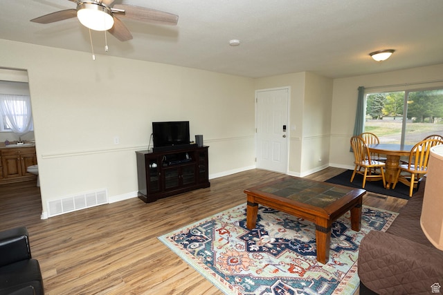 566 S Main St, Lyman, UT 84749 - living room with wood finished floors, baseboards, and ceiling fan